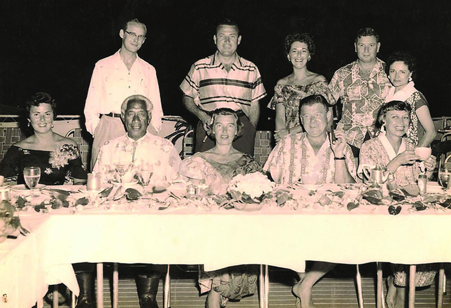 With Duke L-R, seated: Dolly Taylor, Duke Kahanamoku, Mrs. Kahanamoku, Arthur Godfrey, Mrs. Godfrey; standing: Lee Taylor, the president of Hawaiian Airlines, his wife, a Hawaiian Airlines pilot and his wife.