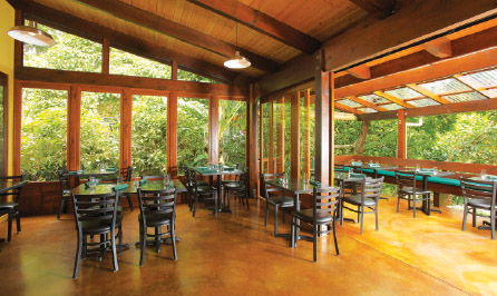 The large “windows” are doors repurposed from a Waiki‘i Ranch remodel. The lānai bench is made of recycled wood, as are the roof beams and rafter support beams.