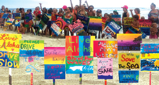 Keiki Surf for the Earth participants with their signs. photo courtesy of Karen Eoff