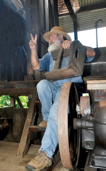 Jim Miller explains coffee processing at the Kona Coffee Living History Farm. photo by Fern Gavelek