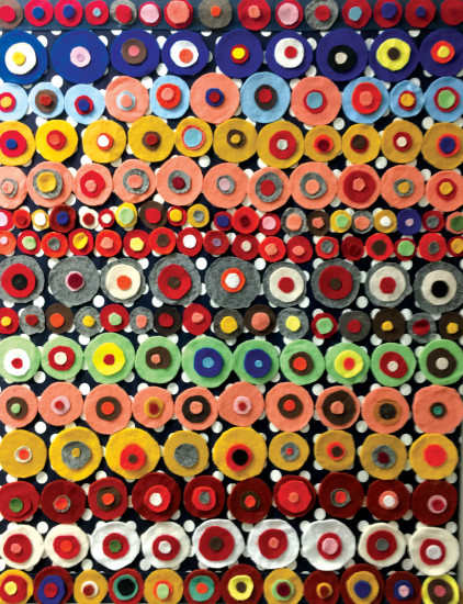 Circles of felt arranged in rows and hung on polka dot fabric create an eye-popping wall display. photo by Paula Thomas
