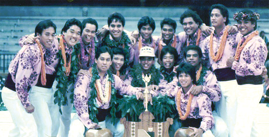 The first trophy in the Kane categories at Merrie Monarch went to the Men of Waimapuna in 1986, under the direction of late Kumu Darrell Lupenui. They portrayed the warriors of Moloka‘i. The young Keala Ching is fourth from left in the back row. Today, he is a kumu hula and founder of Na Wai ‘Iwi Ola in Kona. photo courtesy of “Tribute to Darrell Lupenui"
