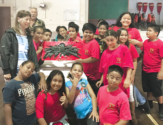 Pahoa Elementary School keiki with the ‘alalā (Hawaiian crow) artwork they made with Uncle D. photo courtesy of Don Elwing
