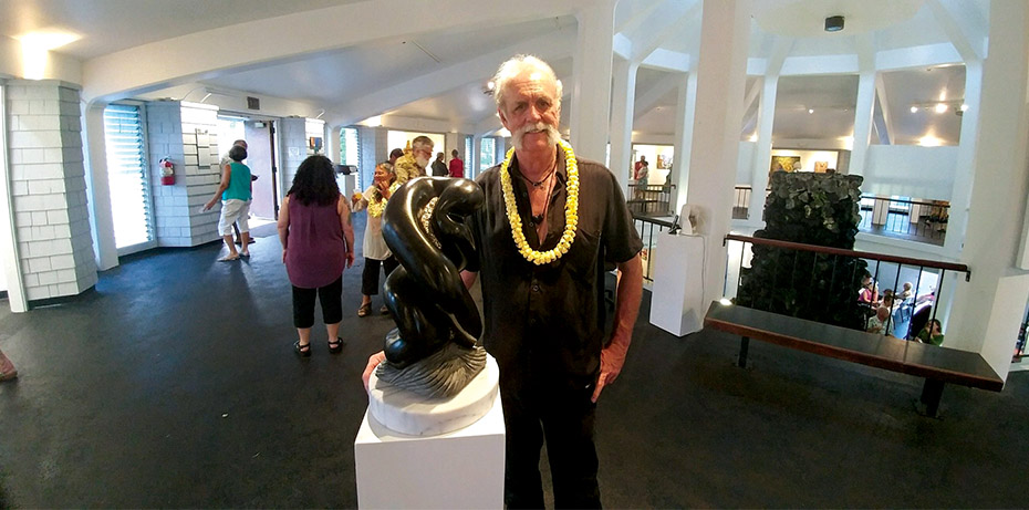 William with sculpture Infinite Love, black granite with bismuth on white marble base, at the Wailoa Center. photo courtesy of Hollyn Johnson
