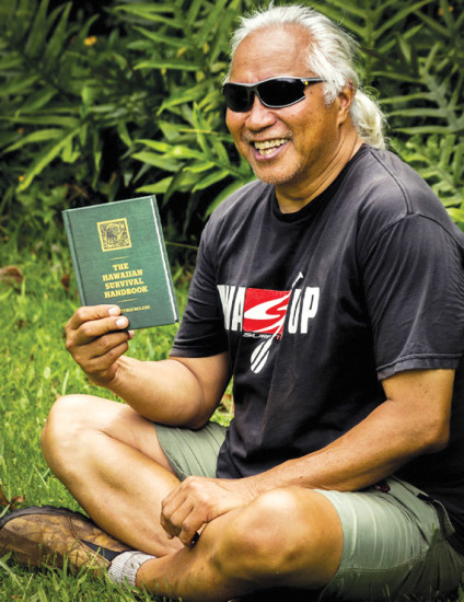 Brother Noland showing his book “The Hawaiian Survival Handbook.” photo courtesy of Brother Noland