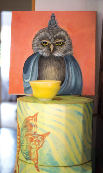An owl painting with an image of Buddha. Marcia says, "The owl represents wisdom and nature, and he's pissed off. I did it right after the election." photo by Sarah Anderson