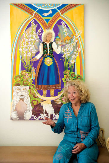 Marcia with her self-portrait that shows her life journey in a mythic style through symbolic images. photo by Sarah Anderson 