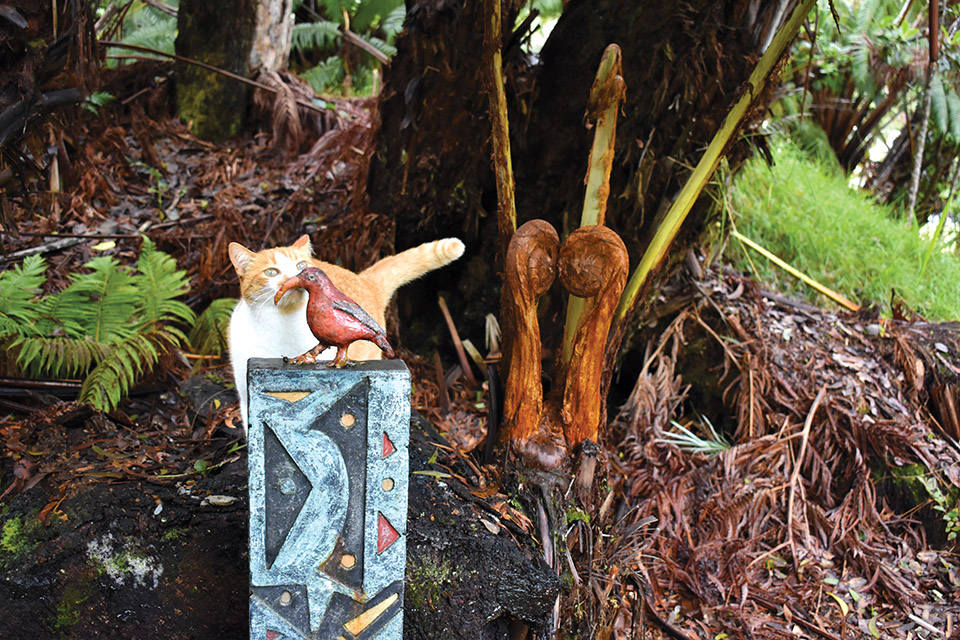 Orangia, Niaulani's official cat in residence, inspects Henry Bianchini's Old Bird in a New World. photo by Alan McNarie