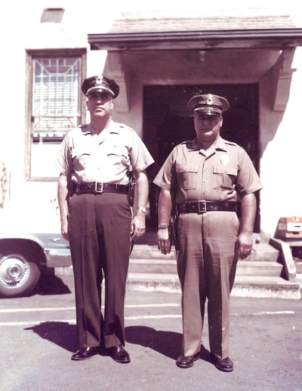 Hilo police officers on the side of building, circa 1960. photo courtesy of Hilo Police Department, County of Hawai‘i