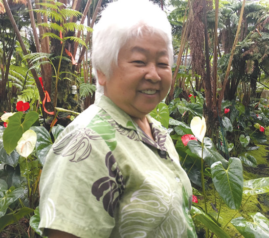 Aiko Sato of Pāhoa stands in her ¼ acre anthurium garden tucked away on an unmarked lane in Pähoa Village. photo by Tiffany Edwards Hunt