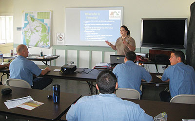 Denise Laitinen teaching Hawai‘i Fire Department class of recruits about Firewise program.