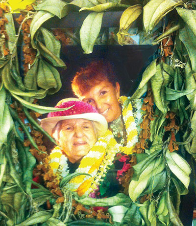 A lei-draped photo of Aunty Dottie Thompson and her daughter, Luana Saiki-Kawelu, the current president and executive director.