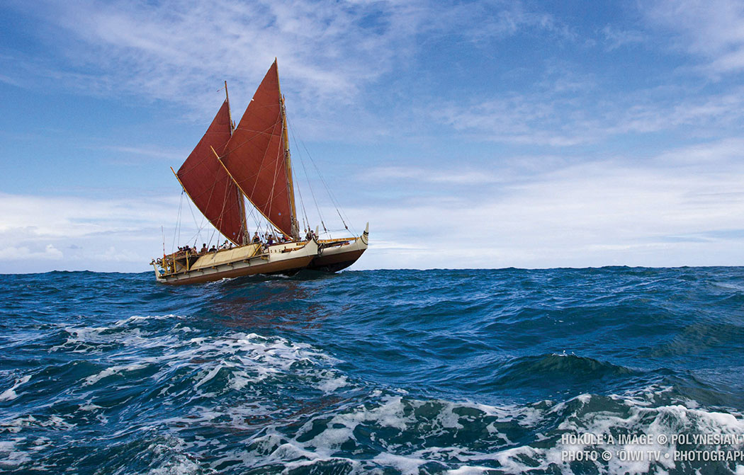 Hōkūle‘a riding the waves. Hōkūle‘a Image ® Polynesian Voyaging Society; Photo © ‘Ōiwi TV. Photographer: Kaipo Kī‘aha