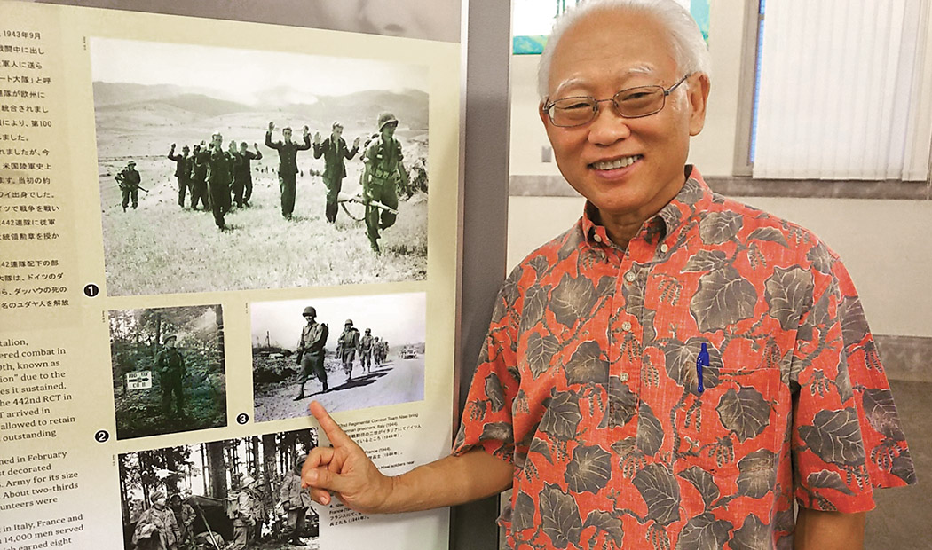 Byrnes Yamashita, chair of the Nikkei Exhibit, pointing to a picture of his father when he was 19 years old, while in Italy with the 442nd Regimental Combat Team. photo courtesy of Byrnes Yamashita