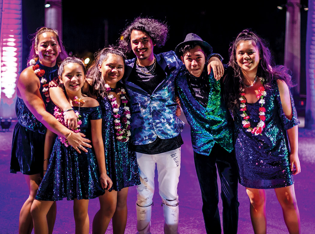 Kūkahi (center) surrounded by his band the Love Machine. From left to right, Mom Maka (background vocals) sister Mālie (rhythm guitar), sister Alana (drummer), brother Keli‘i (keyboards), and sister Monica (bass guitar). 