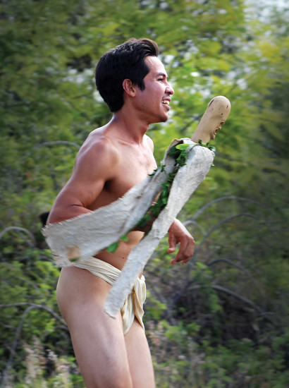 James Akau of Ka‘ū carries the Lono staff to bring mana (power) to the restoration work at Kawa Beach.
