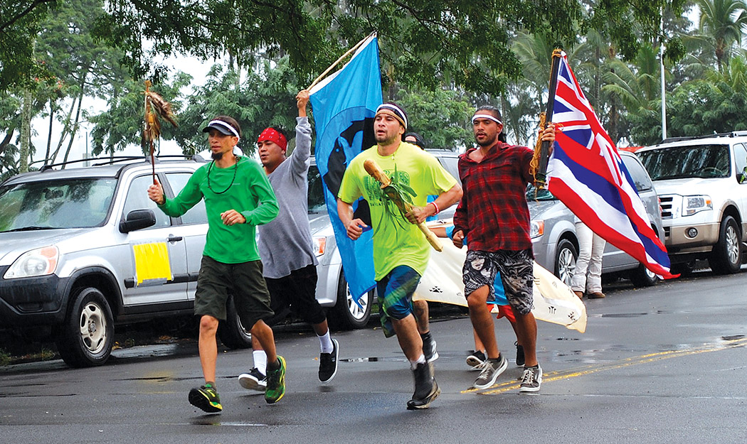 Runners from Northen California tribes carry their prayer staffs and flags in support of fellow Kanaka Maoli runners with Lono staff.