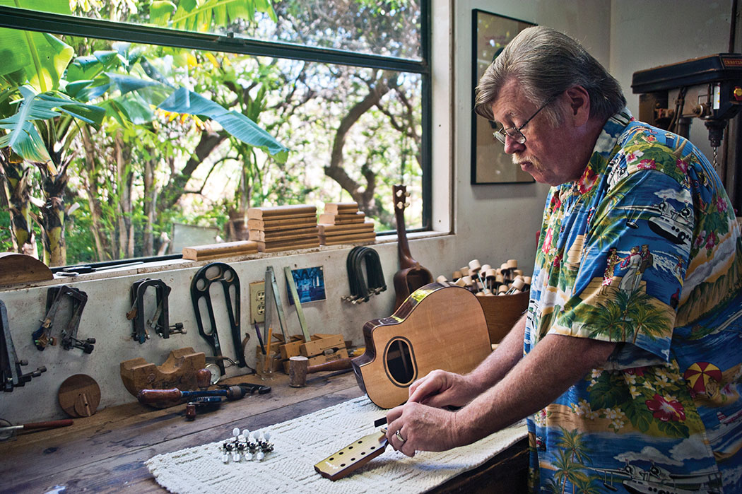 Dennis filing the nut on an eight-string baritone ‘ukulele in his Nā‘ālehu shop. photo courtesy of Peter Anderson