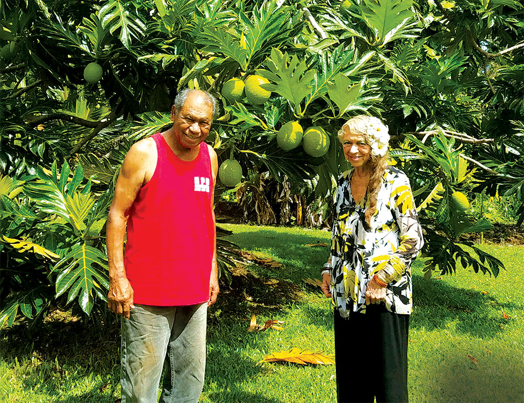 After a morning of yard work, Uncle Louie and Aunty Leifi take a break in front of their prolific ‘ulu (breadfruit) tree. photo by Marcia Timboy