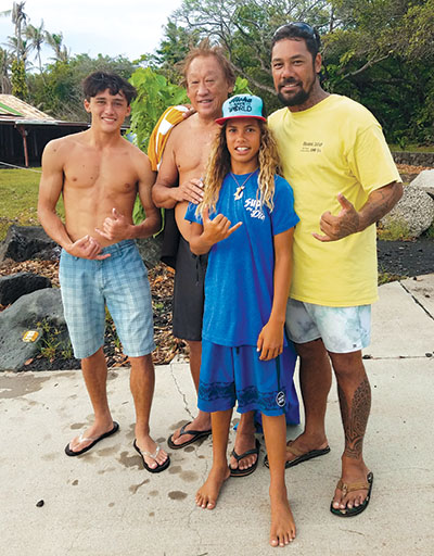 Pono Hirakami, his dad Steve Hirakami, Tamaroa Kalama, and his dad Ikaika Kalama (left to right) share a generational love for surfing and for Pohoiki. photo by Marcia Timboy