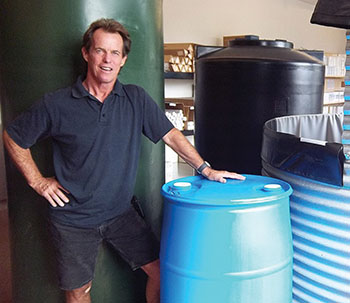 Verne Wood, owner and founder of WaterWorks is shown with a few of the company’s recently-expanded line of FDA-certified, food-grade, plastic storage tanks.
