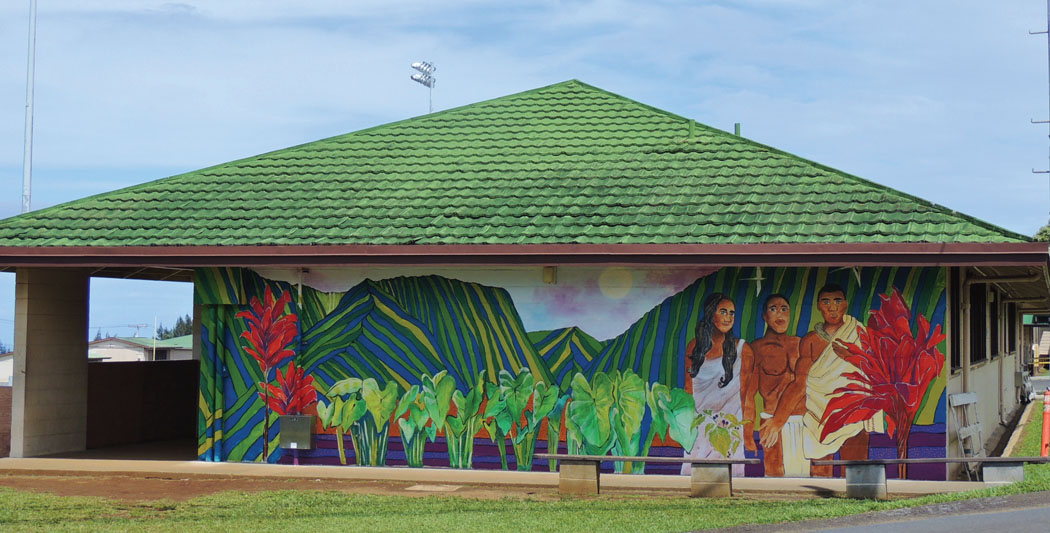 Facing Pakalana Street, this mural features elements of traditional Hawaiian culture, such as the red ti plant and essential kalo plant, and pays tribute to Waipi‘o Valley. photo by Catherine Tarleton