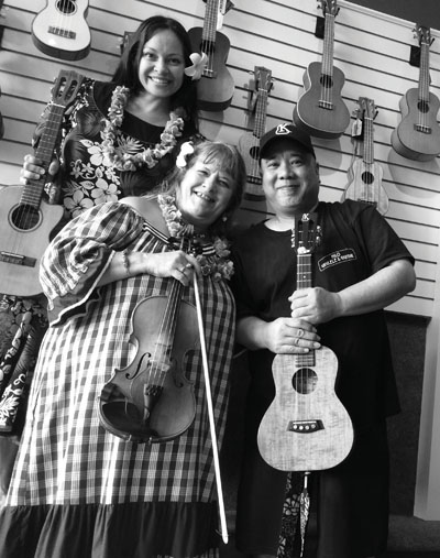 Tiana and Hawk with long-time benefactor Rick, owner of Hilo Ukulele and Guitar Shop. photo courtesy of Matty Malone Jennings