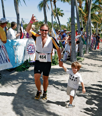 Marathoner Bob Brown (35) owns Eye Expression Photography based in Kailua-Kona. Specialties include family and visitors’ photographic records of “Life’s Special Moments.” (www.eyeexpression.com) He also enjoys spending time with his wife Naomi and children Casey and Calvin, while working in a movie or game of golf, too.