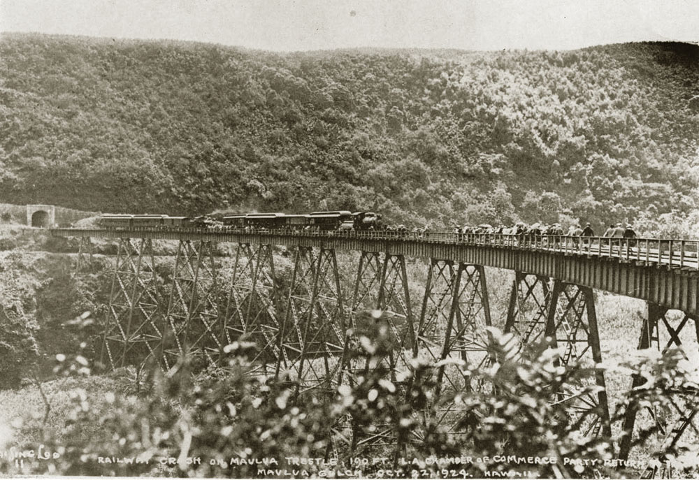 The 190-foot-high Maulua Trestle on the Hawai’i Consolidated Railway, October 22, 1924, shortly after the train on the left had hurtled out of the tunnel and plowed into the train at the right, which had stopped to let passengers get off to view the scenery. Surprisingly, nobody was hurt. From "Early Hawaiian Bridges," Robert C. Schmitt