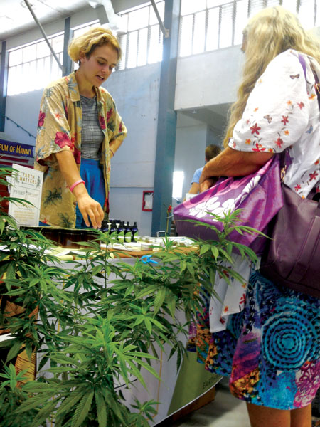 Vendors at the Hawai‘i Cannabis Awareness Conference, held inside Hilo’s Afook-Chinen Civic Auditorium in mid-June, display their wares and help answer customer questions about CBD and other hemp products. photo by Stefan Verbano