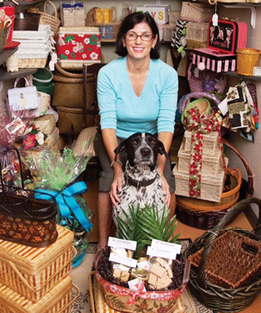Tammy Sullivan and pal Duke with a display of gift baskets.