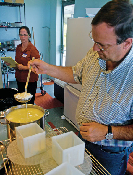 Eric Bellos of O‘ahu is placing the curd into molds.