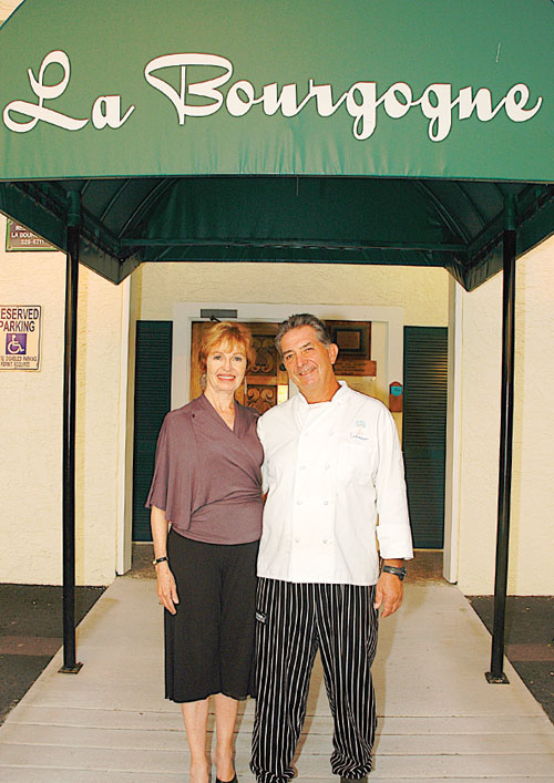 Restauranteurs Colleen Moore and Ron Gallaher at the entrance of Kona’s Restaurant La Bourgogne.