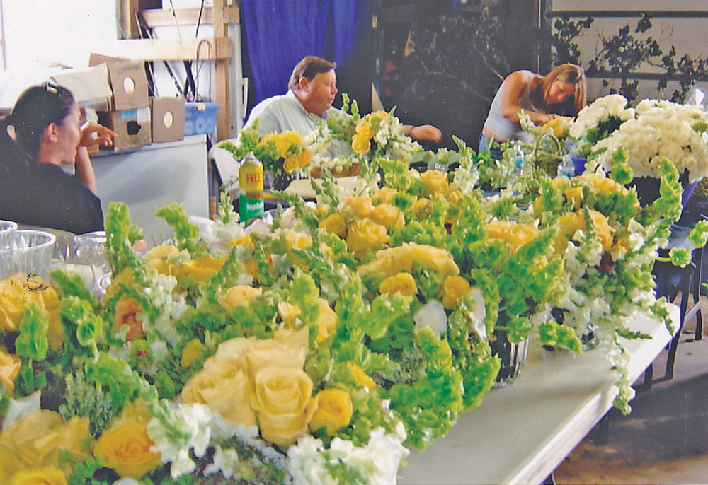 Creating color and style for an island wedding in 2005. Calling his style quasi-Old Island English, Scott uses temperate flowers like agapanthus, dahlias, snapdragons and roses with native plants and island orchids. photo courtesy Scott Seymour