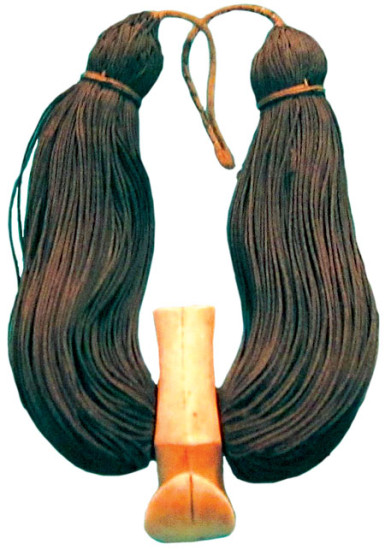 Lei niho palaoa (neck ornament), 19th century. Carved sperm whale tooth, braided human hair, olona cordage. photo from en.wikipedia.org/wiki/Lei_niho_palaoa