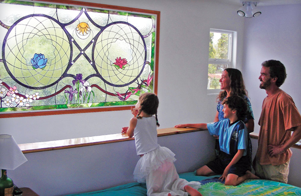 The Harmon family of Waimea admires a window installation in their home. From left to right: Briana, Devyn, Valerie and Sean Harmon.