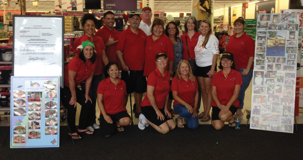 In 2013, JDMF took 50 families with 133 children holiday shopping at the former Kona Kmart. Participating volunteers, who call themselves “Jonathan’s Helpers,” included from top left: Shaula Tualaulelei, Randy Morris, George Handgis, Rob McGuckin, Roz Peterson, Penny Cho, Ramona Amougis, Trish Doyle, Kristina Peterson. From bottom left: Charyl AhSing, Allie Morris, Denise McGuckin, Peggy Kelly, and Sharon Handgis. Not pictured is Tony Amougis, Pati Tualaulelei, and Walter Cho who were staffing the JDMF’s Heaven Sent hotdog cart.