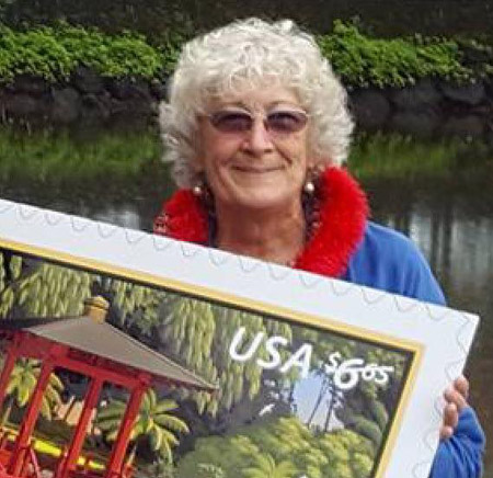 K.T. holding a US postage stamp, the first time a Hilo location or a US Japanese garden appeared on a stamp. photo courtesy of Jeff Burton