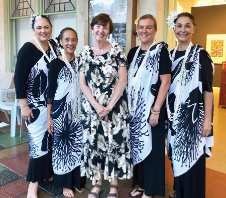 Dinnie flanked by four of “The Hula Sisters” who danced during the November 2018 Downtown Hilo Black and White Night. photo courtesy of Carlene Wolf