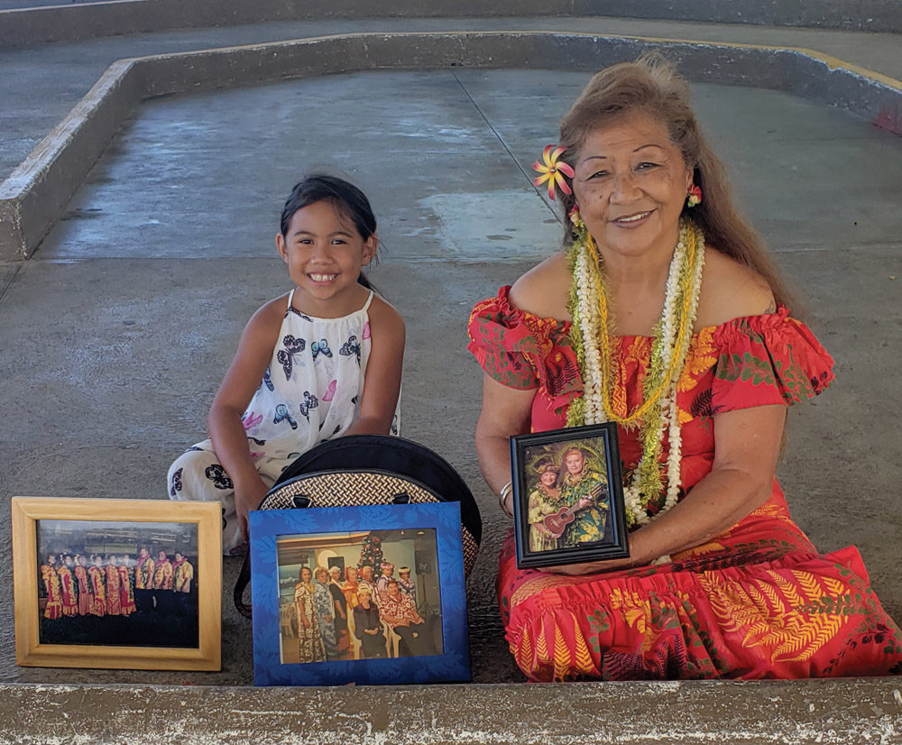 “He drew the dance out of me,” says Pi‘ilani Rodrigues, pictured here with her granddaughter, holding photo of Stan Kaina. photo by Sara Stover