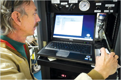 Hilo resident Steve Ryan in 2010, at the Mauna Loa Observatory NOAA computer for the carbon dioxide analyzer. photo courtesy of NOAA