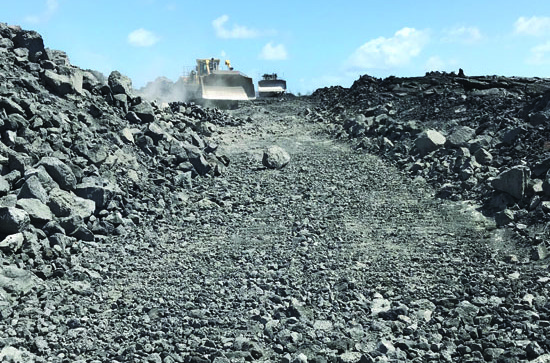 In July 2019, bulldozers clear a path through the lava field from the 2018 Lower Puna Eruption along the new upper section of Highway 132 in order to build the new roadway, connecting the old highway terminus near Lava Tree State Park with the west side of the Highway 132 Kīpuka. photo courtesy of Hawai‘i County Department of Public Works