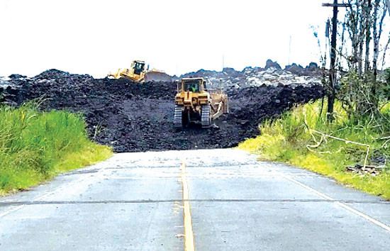 First day of work on the new upper section of Highway 132, June 10, 2019. With the yellow-lined terminus of the old highway in the foreground, bulldozers begin to carve out a path through the 2018 Lower Puna Eruption lava field east of Lava Tree State Park. photo courtesy of Hawai‘i County Department of Public Works