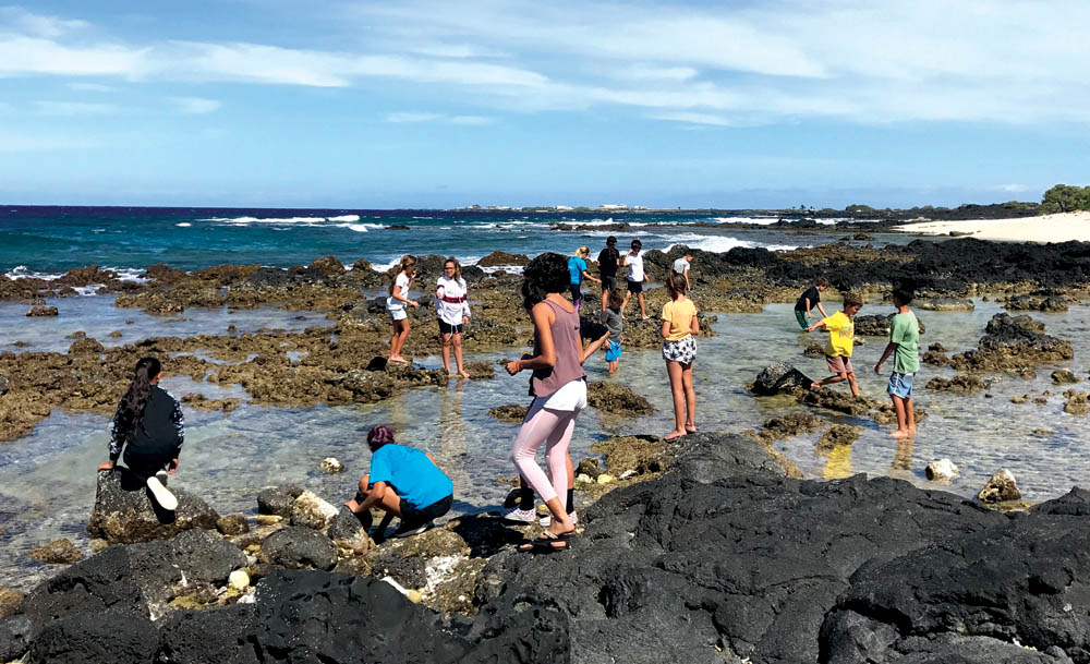West Hawai‘i Explorations Academy students monitor the shoreline at ‘O‘oma in North Kona. photo courtesy of the Kohanaiki ‘ohana