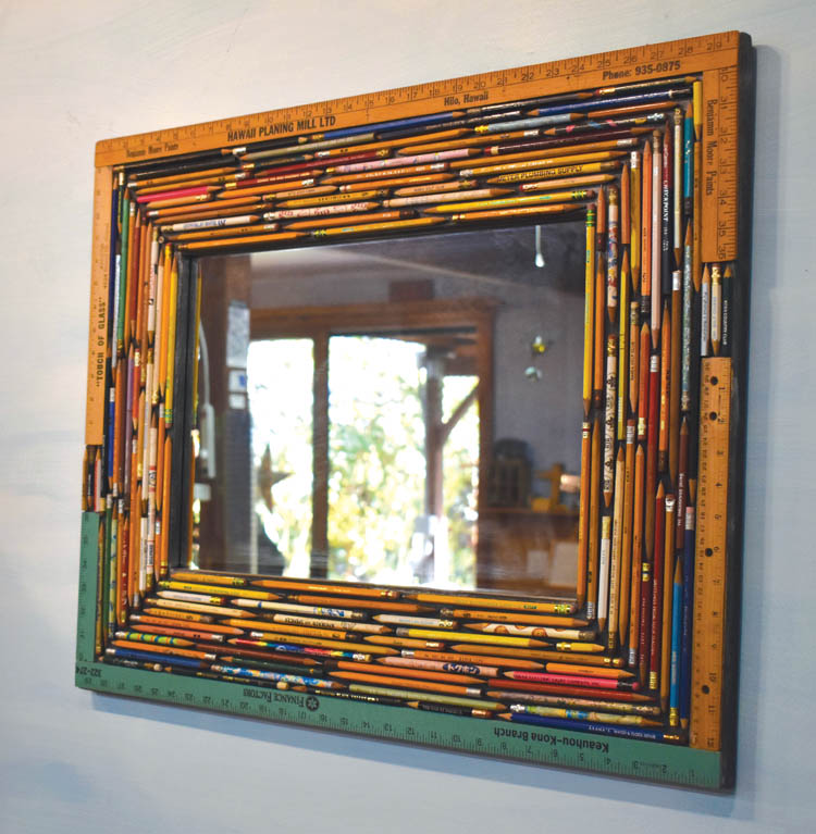 Kathleen used pencils and rulers collected from her 30 years of instructing workshops to create colorful mirror frames. The tools used by past students were affixed to recycled pine wood shelves. photo by Fern Gavelek