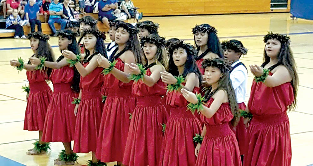 Na haumana (students) performing at the Malia Craver Hula Kahiko competition on O‘ahu for secondary school students to showcase their achievements in ancient hula and chant. They have won high honors there.