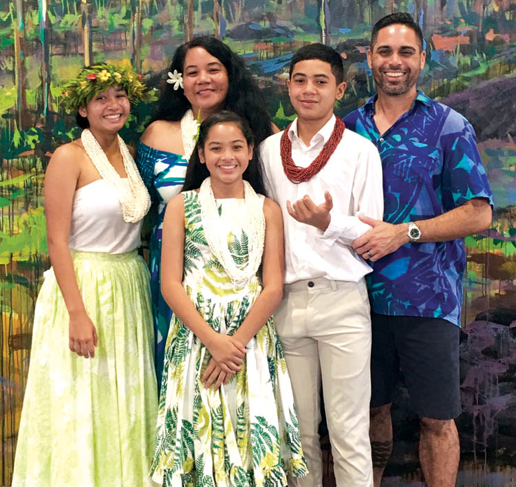 The Harman family welcoming cruise ship visitors as they come off the boat at Hilo Harbor in Keaukaha. From left: oldest daughter Kalāmanamana, now a freshman at Dartmouth College; Pele, who is expecting their fourth child; daughter Nali‘ipo‘aimoku, 13; son Ka‘umu‘ali‘i, 14, and Kekoa. All the children are fluent in ‘ōlelo Hawai‘i, their primary language at home.